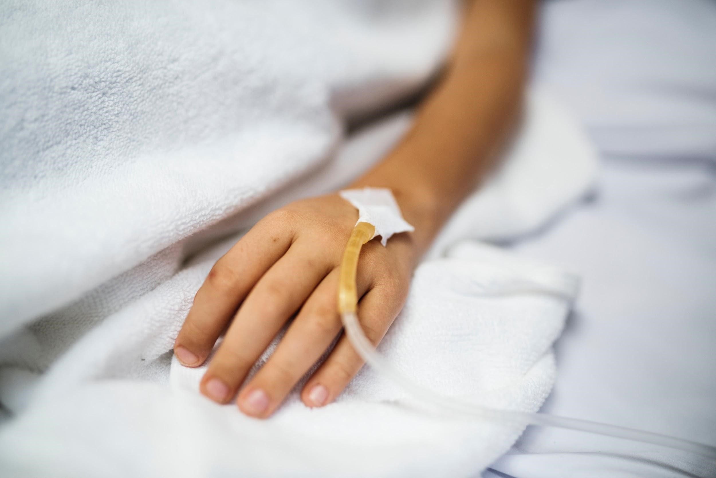 hand with iv line attached