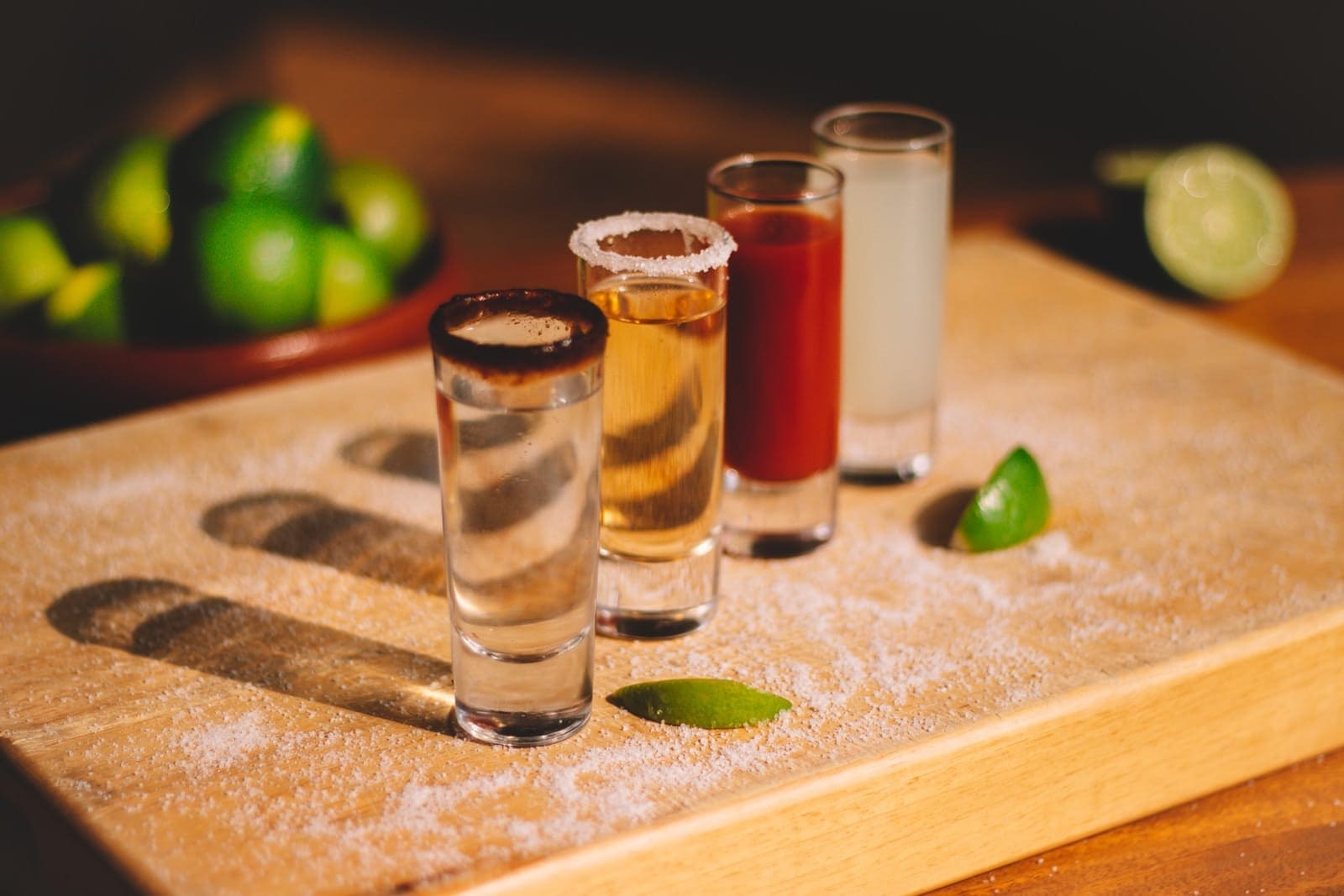 3 clear drinking glasses on brown wooden chopping board