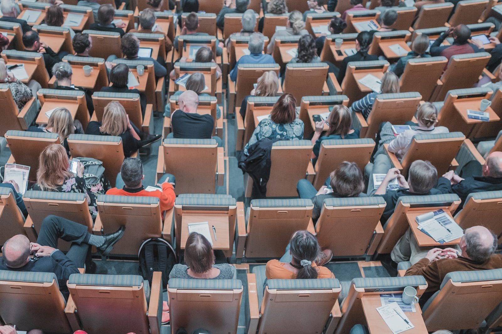 universities high-angle photography of group of people sitting at chairs