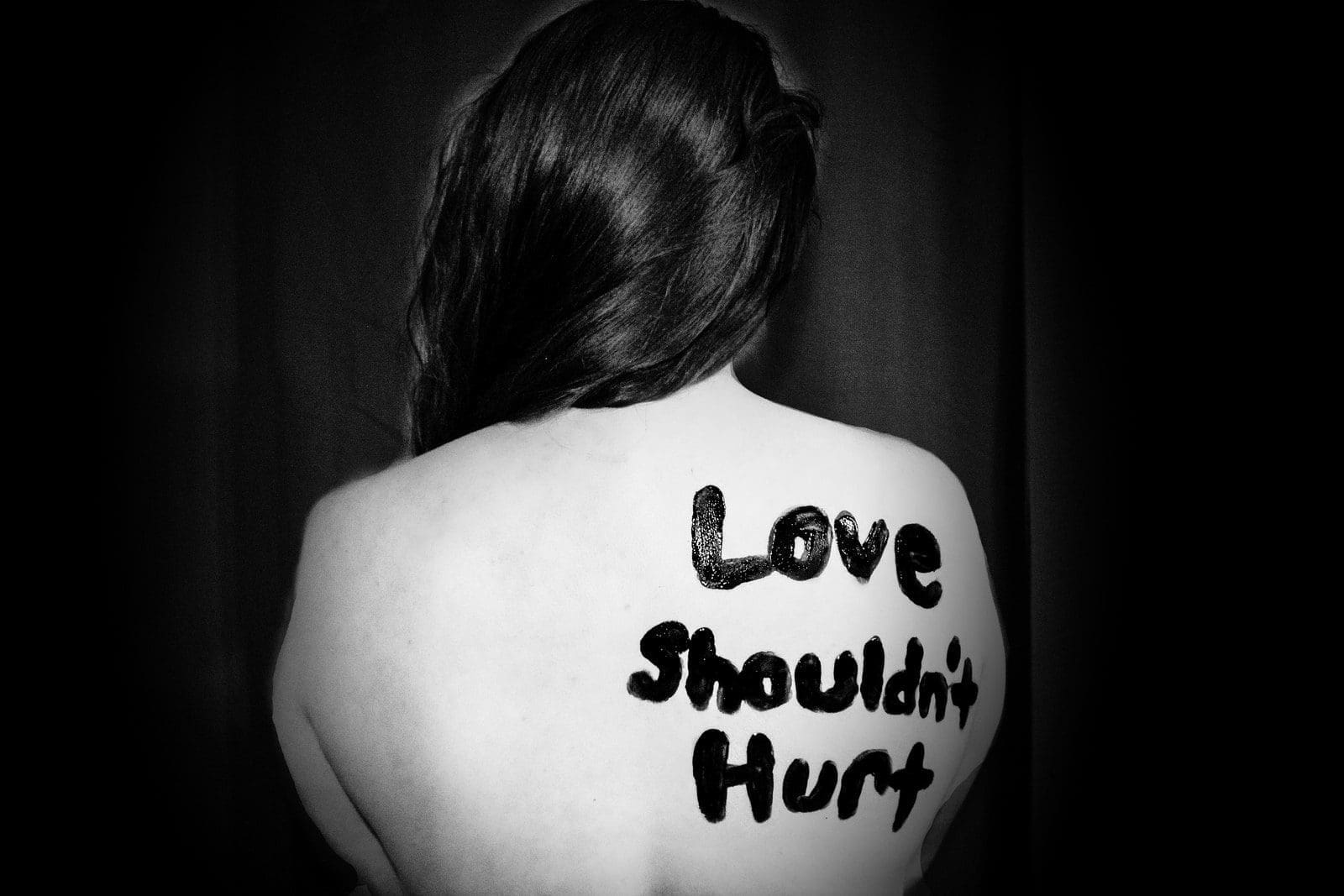 family law love shouldn't hurt-printed on back of woman