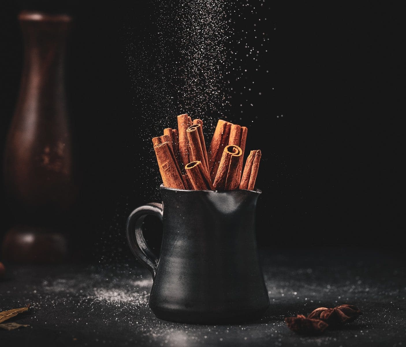 cinnamon for chest acne black ceramic jar on black surface