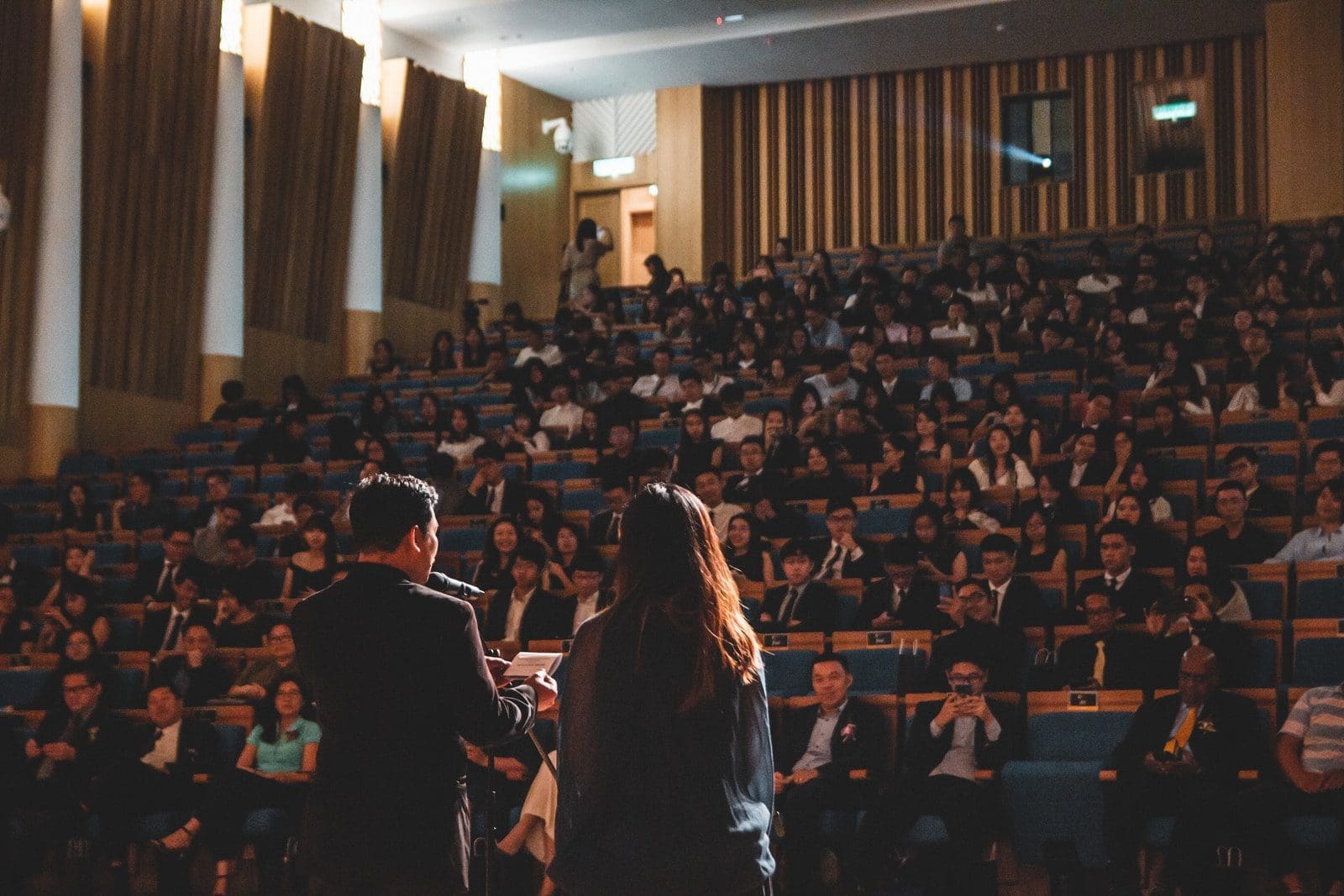 people sitting on chair inside room public speaking