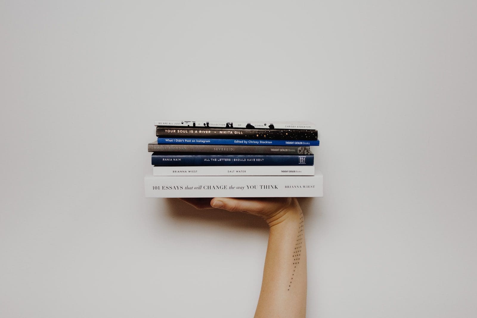 inspirational books for students person holding pile of books