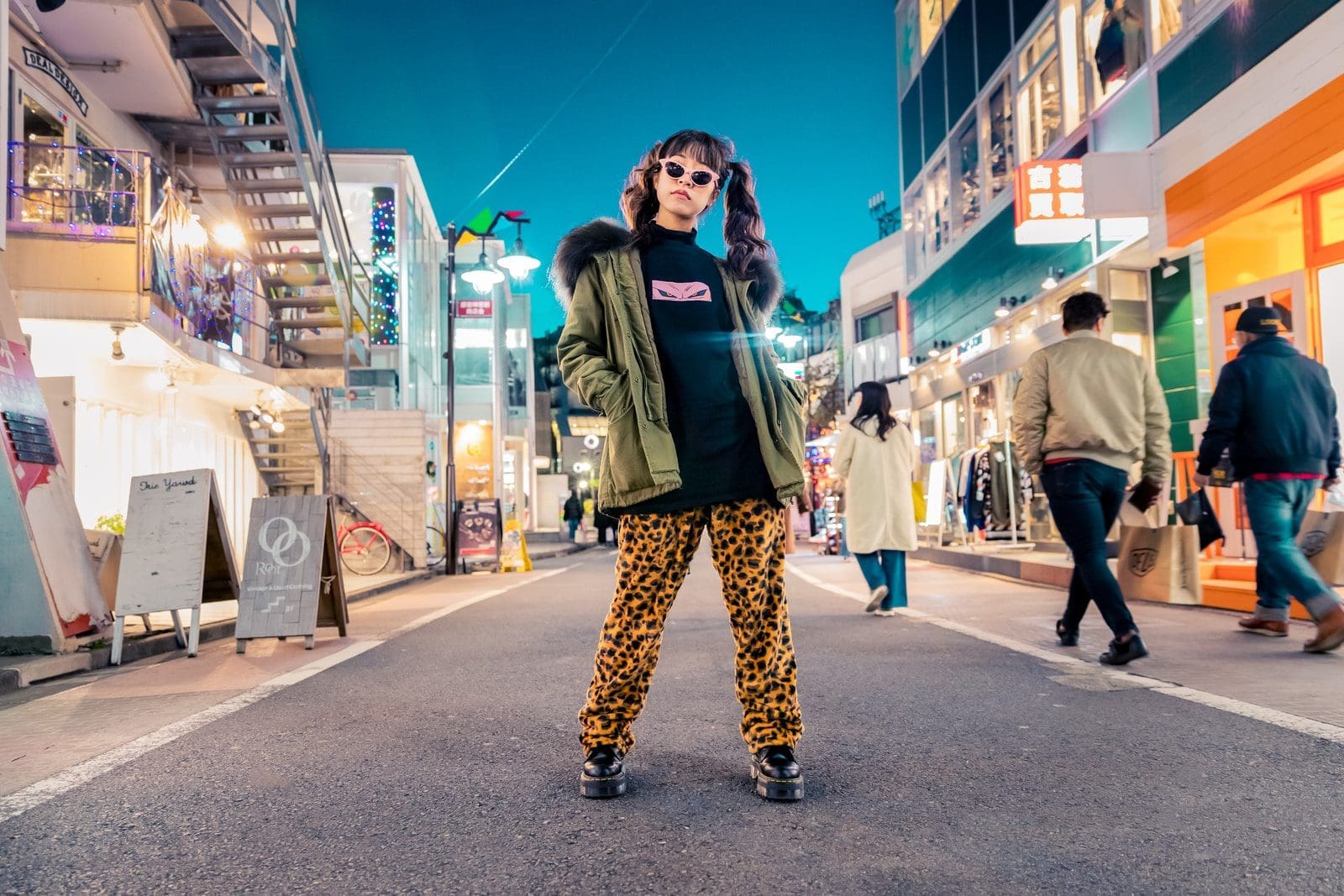 Sense of Style woman in green jacket stands and pose on street