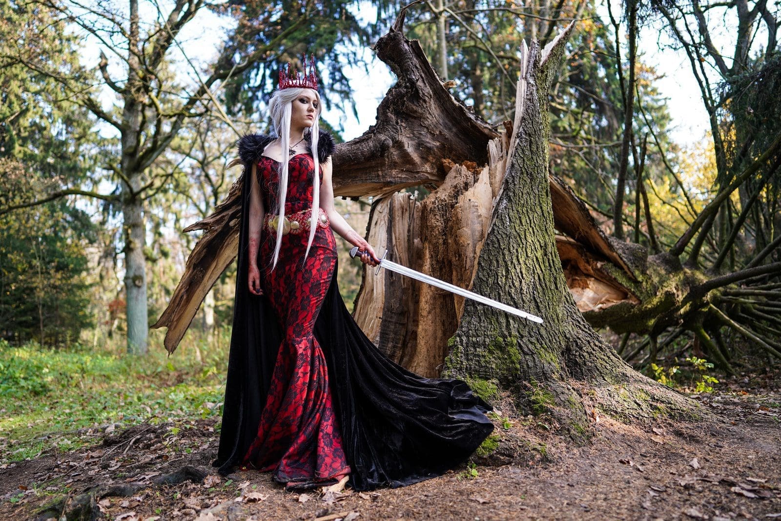 woman wearing red dress holding sword