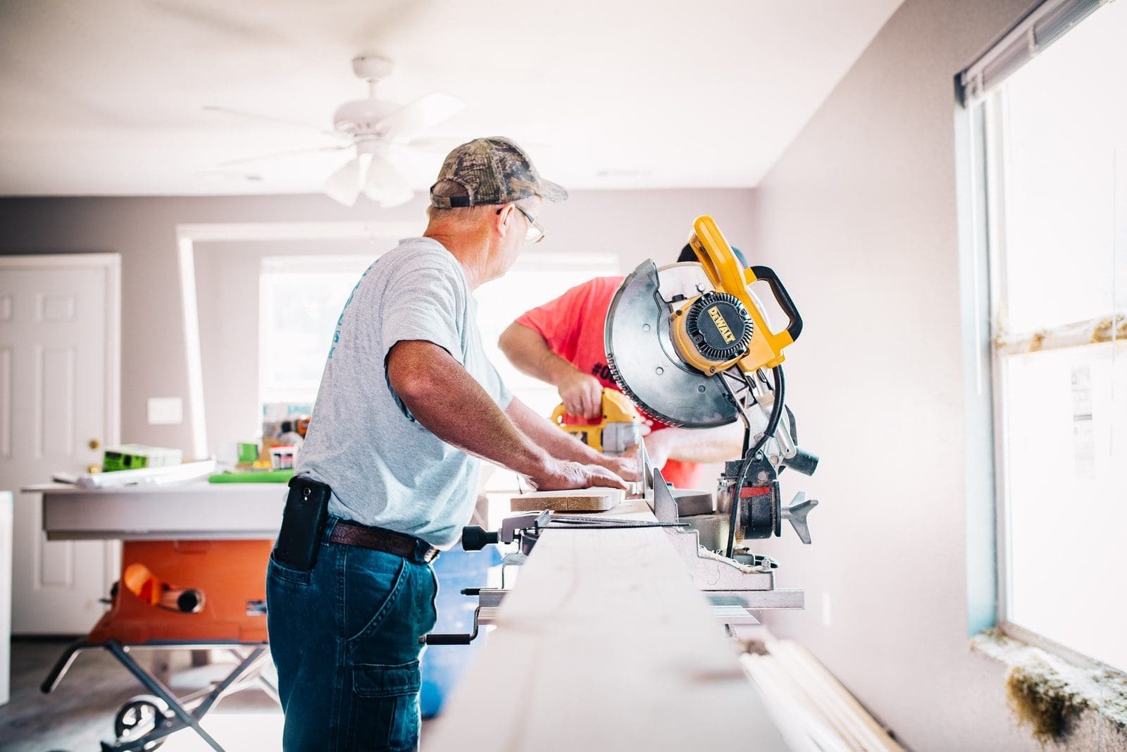 home renovation man standing infront of miter saw