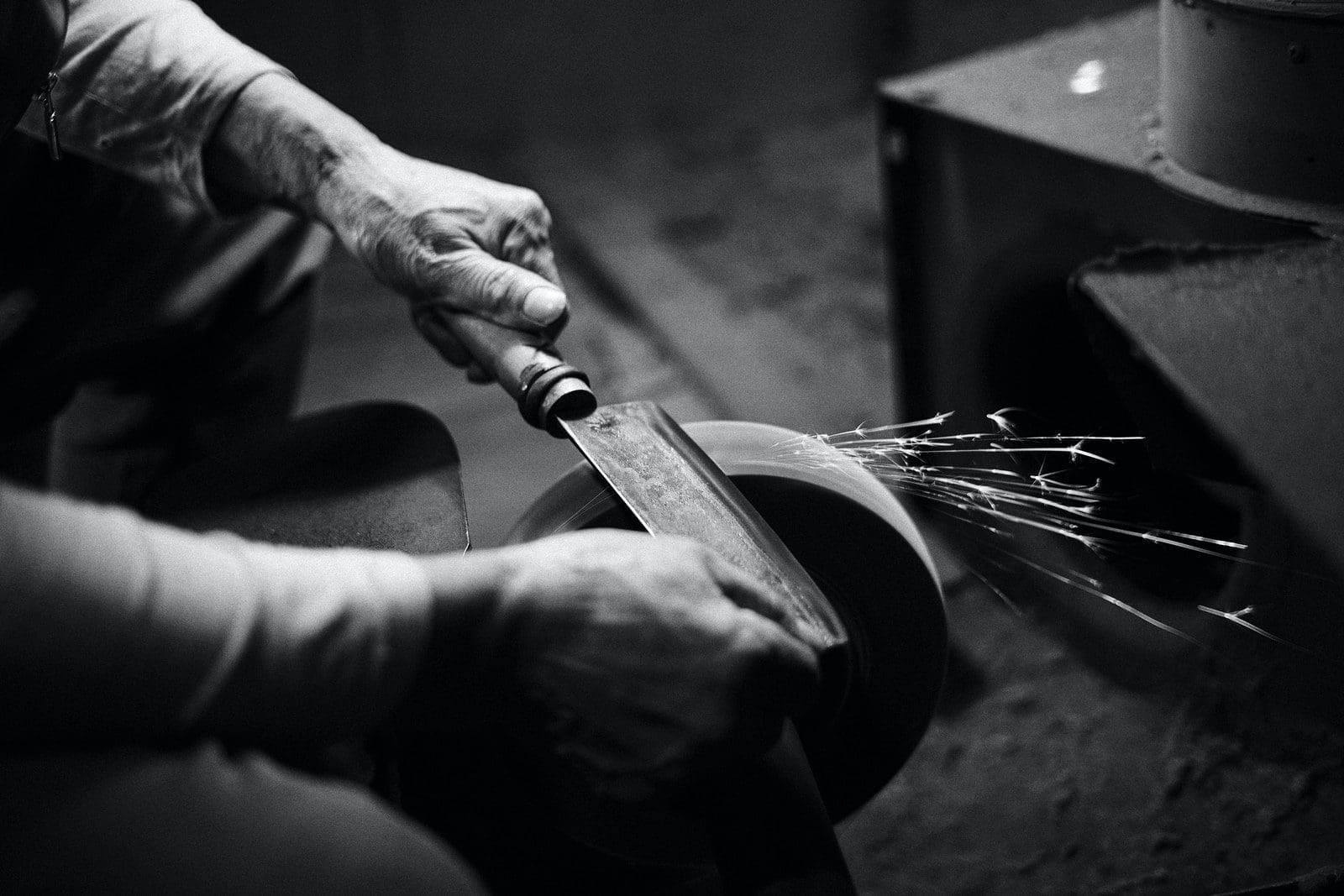 knife making person grinding cleaver