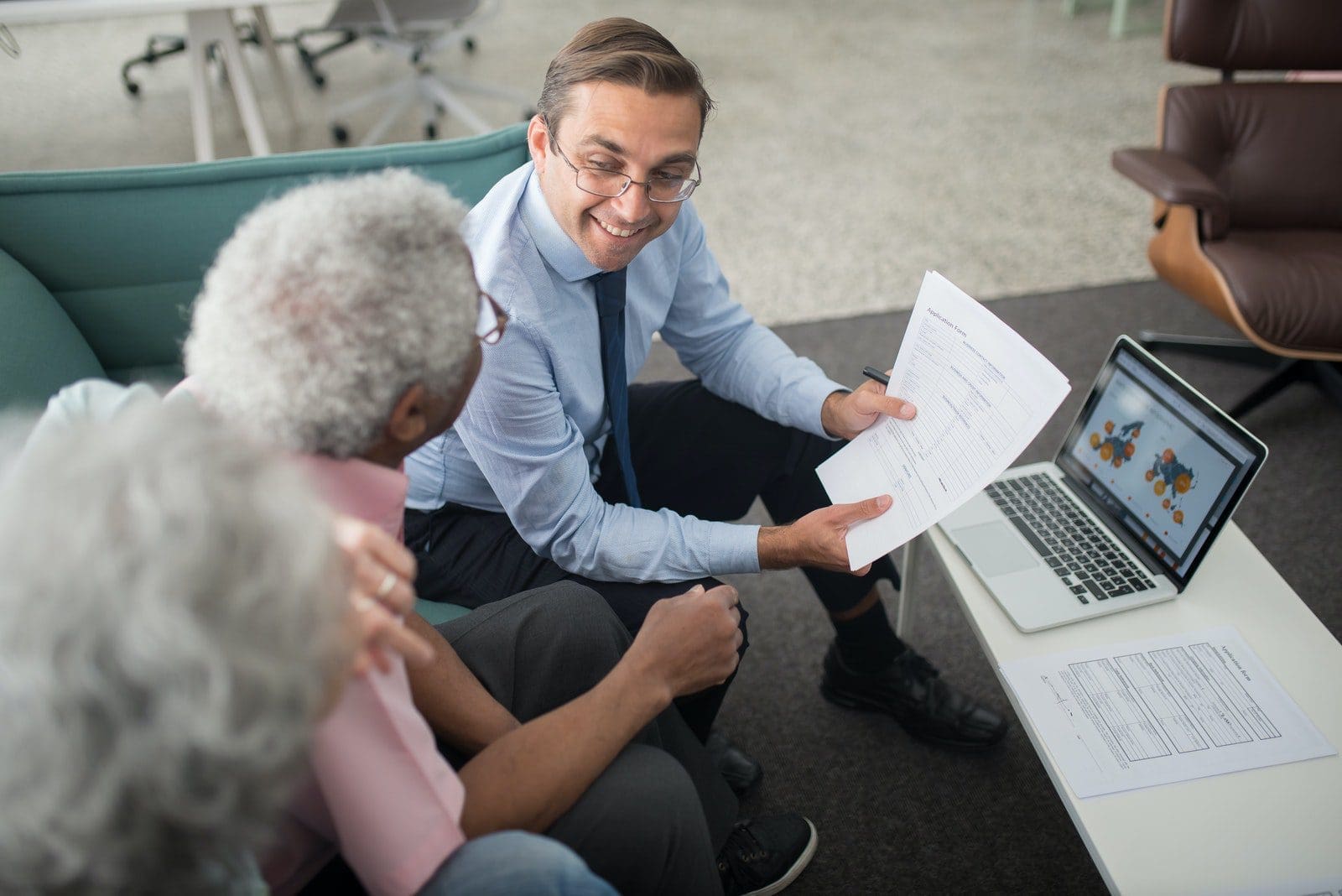 life insurance Agent Showing Documents to an Elderly Man