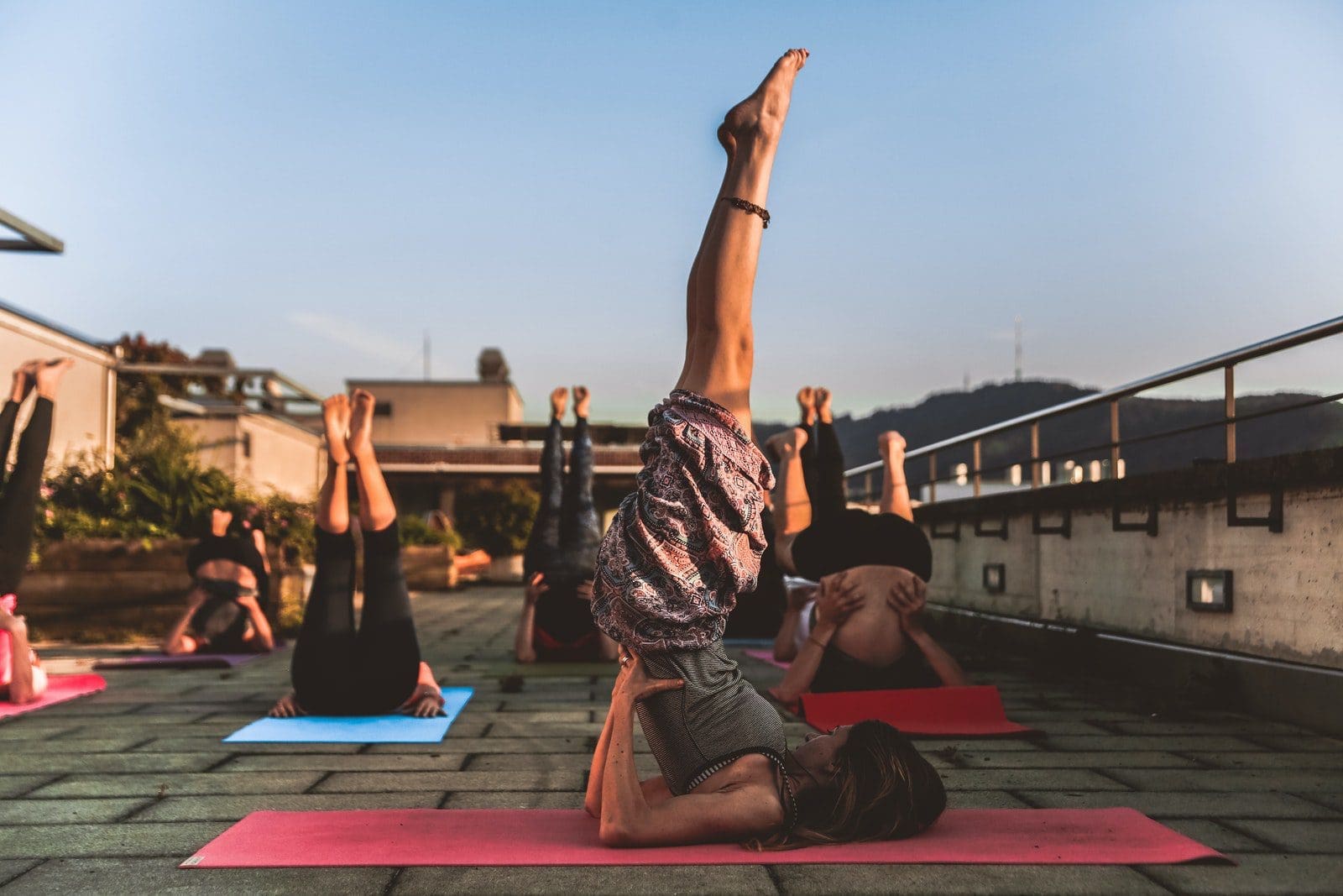 yoga classes Group of Women Lying on Yoga Mat Under Blue Sky