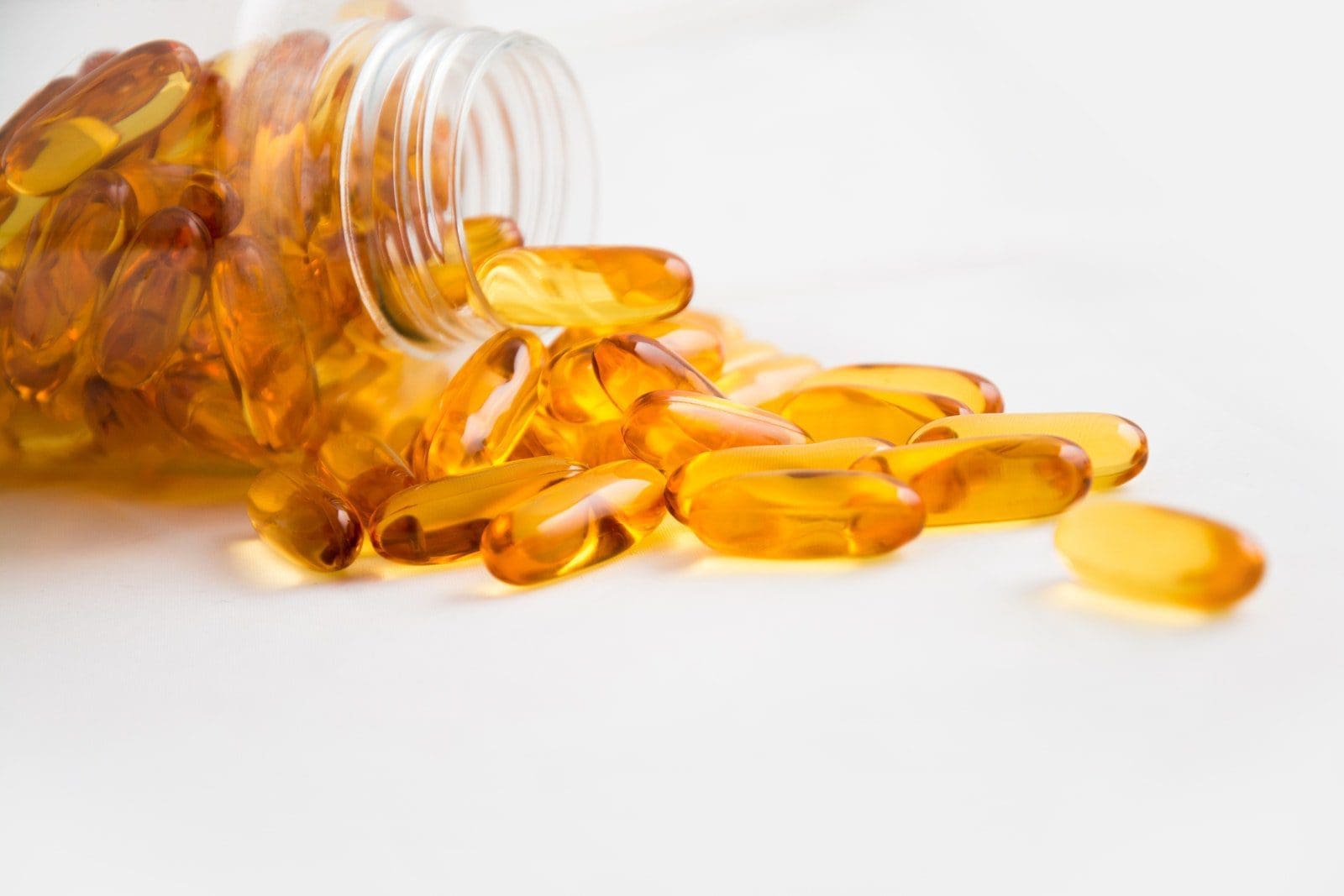 pre-workout supplements Spilled Bottle of Yellow Capsule Pills