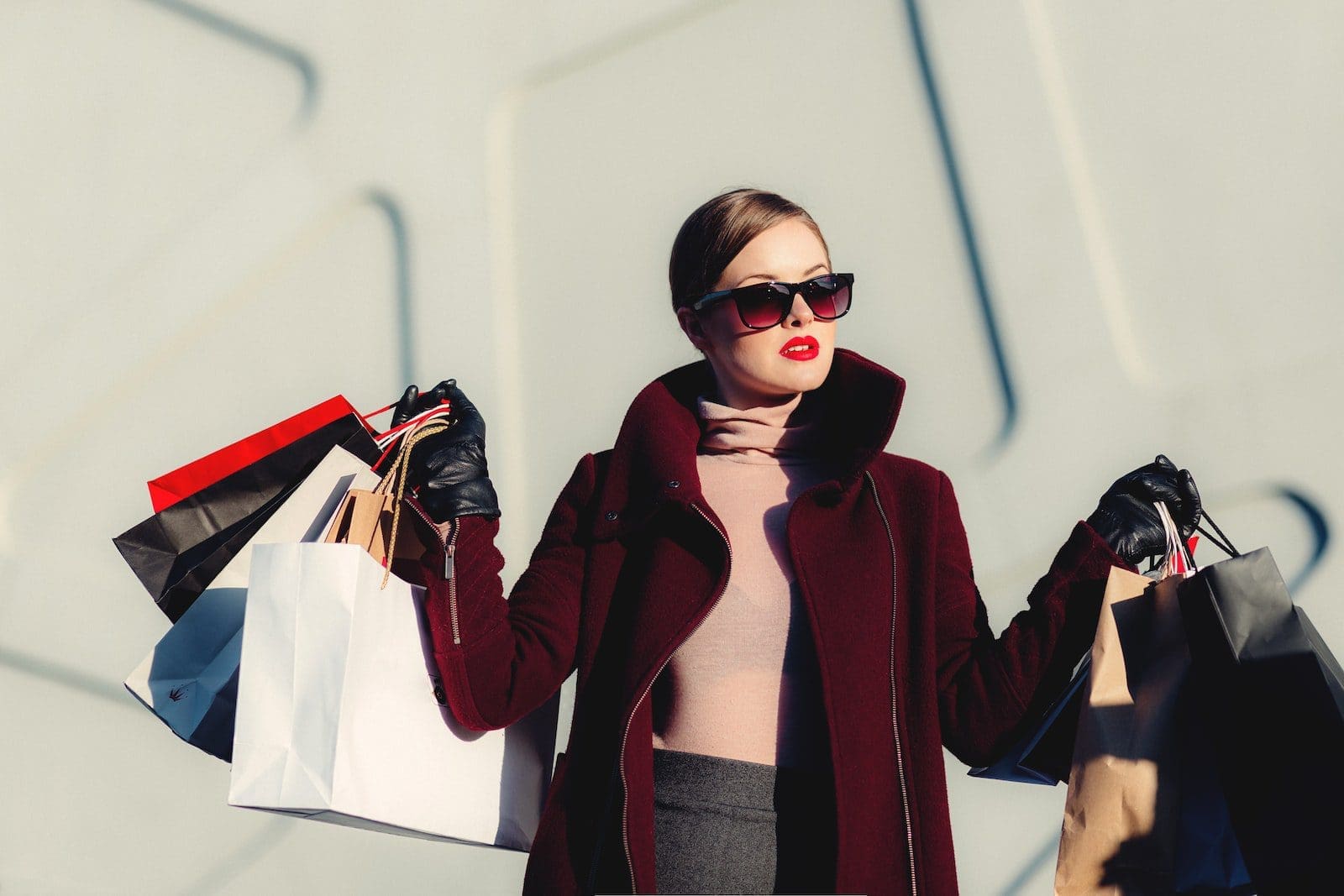 sae money shop online photo of woman holding white and black paper bags