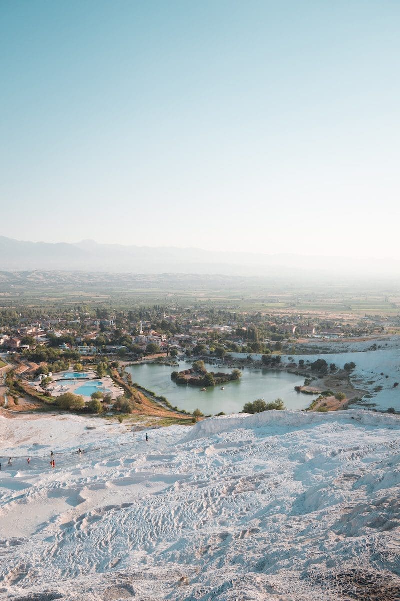 aerial photography of houses near body of water under blue and white sky during daytime Pamukkale