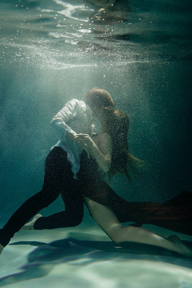 A Couple Dancing and Kissing Underwater