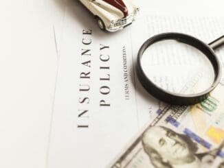 a magnifying glass sitting on top of a piece of paper Insurance calculator