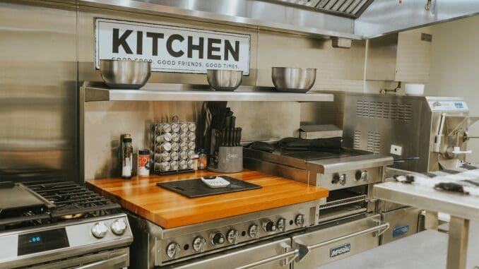 a smart kitchen with stainless steel appliances and a wooden counter